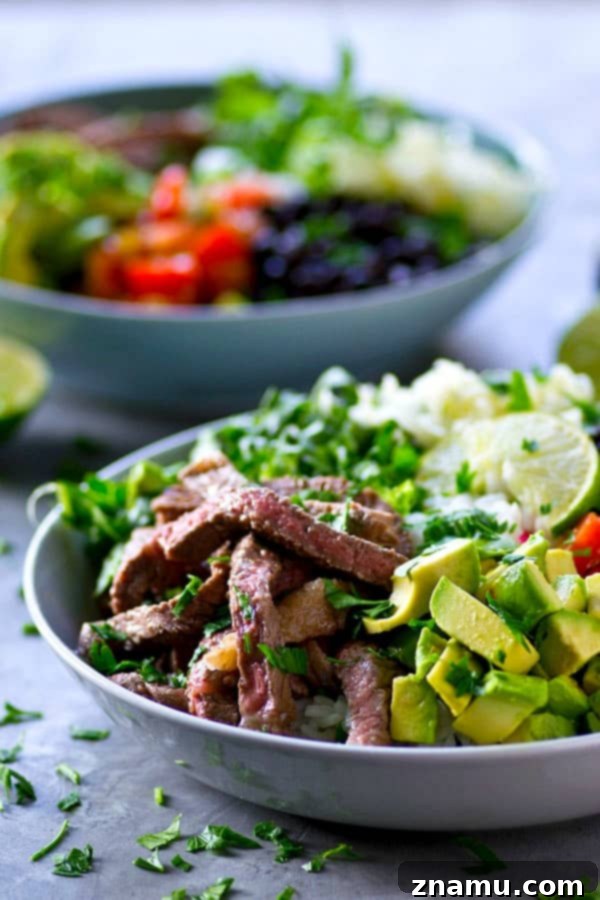 Juicy, flavorful cilantro lime grilled steak and all the burrito 'fixins come together in these loaded grilled steak burrito bowls and it'll be on the table in only an hour!