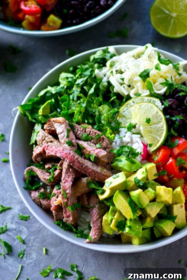 Juicy, flavorful cilantro lime grilled steak and all the burrito 'fixins come together in these loaded grilled steak burrito bowls and it'll be on the table in only an hour!