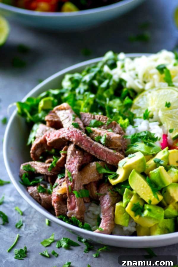 Juicy, flavorful cilantro lime grilled steak and all the burrito 'fixins come together in these loaded grilled steak burrito bowls and it'll be on the table in only an hour!