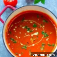 Creamy Basil Roasted Tomato Soup with Charred Corn in a bowl.