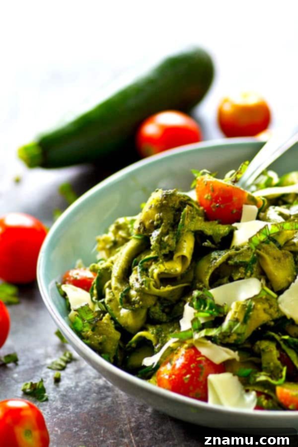 Smooth, garlicky roasted garlic spinach pesto coats every inch of this summery zucchini ribbon salad and it's all tossed with tons of juicy cherry tomatoes and grated Parmesan.