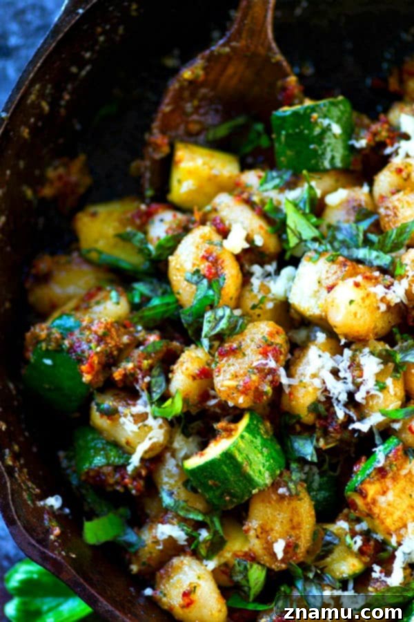 Gnocchi with Sun-Kissed Tomato Pesto and Smoky Zucchini 4 Sun-Dried Tomato Pesto Gnocchi garnished with fresh basil
