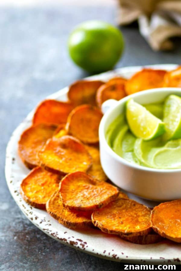 Kickin' Cajun Lime Sweet Potato Chips are perfectly crisp with just the right amount of heat and cooled down with a creamy avocado dip.--just try to eat only one!