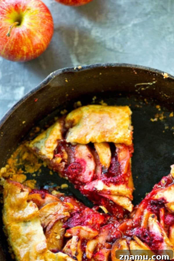 Sweet & Tart Skillet Apple Raspberry Galette 3 Close-up of a homemade apple raspberry galette in a cast iron skillet