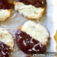 Crisp, chewy coconut cookies are dipped half in semisweet chocolate and half in white chocolate and the result is a batch of GORGEOUS black and white coconut cookies perfect for a fancier event.