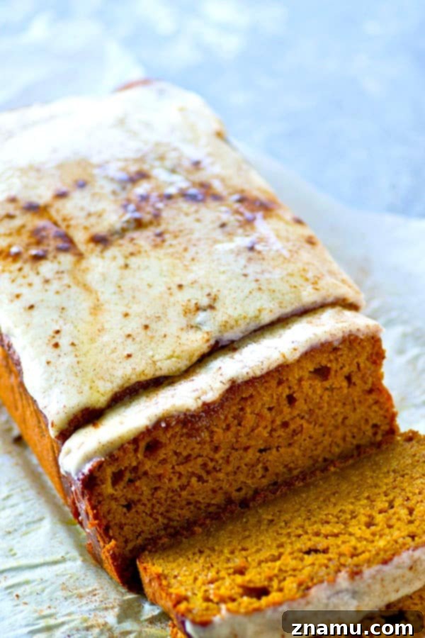 Nutty Brown Butter Pumpkin Loaf with Creamy Glaze 4 Overhead shot of a full loaf of Frosted Browned Butter Pumpkin Bread, garnished with a sprinkle of spice