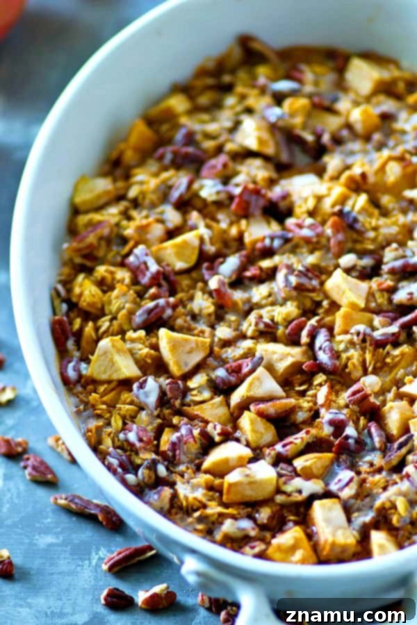 Apple Pie Oatmeal Bake 5 A warm slice of Glazed Apple Pie Baked Oatmeal on a plate, with golden-brown crust and juicy apple pieces visible, ready for breakfast.