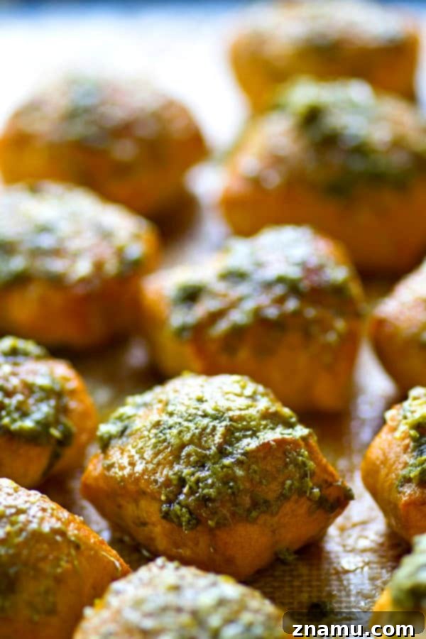 Pillowy Pesto Parmesan Pretzel Bites 3 Close-up of freshly baked Parmesan Pesto Soft Pretzel Bites on a baking sheet