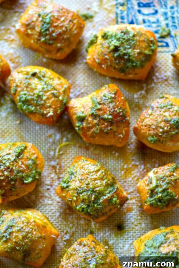 Pillowy Pesto Parmesan Pretzel Bites 5 Multiple Parmesan Pesto Soft Pretzel Bites cooling on a wire rack after baking