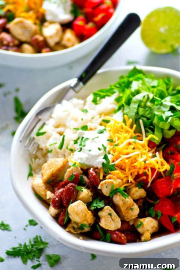 Spicy homemade pico de gallo and all the burrito bowl fixins' are piled into these chicken burrito rice bowls that can be meal prepped completely ahead of time!