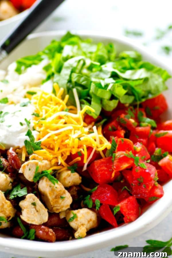 Spicy homemade pico de gallo and all the burrito bowl fixins' are piled into these chicken burrito rice bowls that can be meal prepped completely ahead of time!