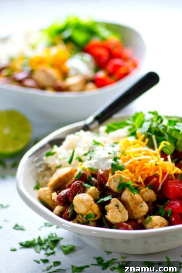 Spicy homemade pico de gallo and all the burrito bowl fixins' are piled into these chicken burrito rice bowls that can be meal prepped completely ahead of time!