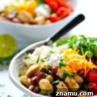 Spicy homemade pico de gallo and all the burrito bowl fixins' are piled into these chicken burrito rice bowls that can be meal prepped completely ahead of time!
