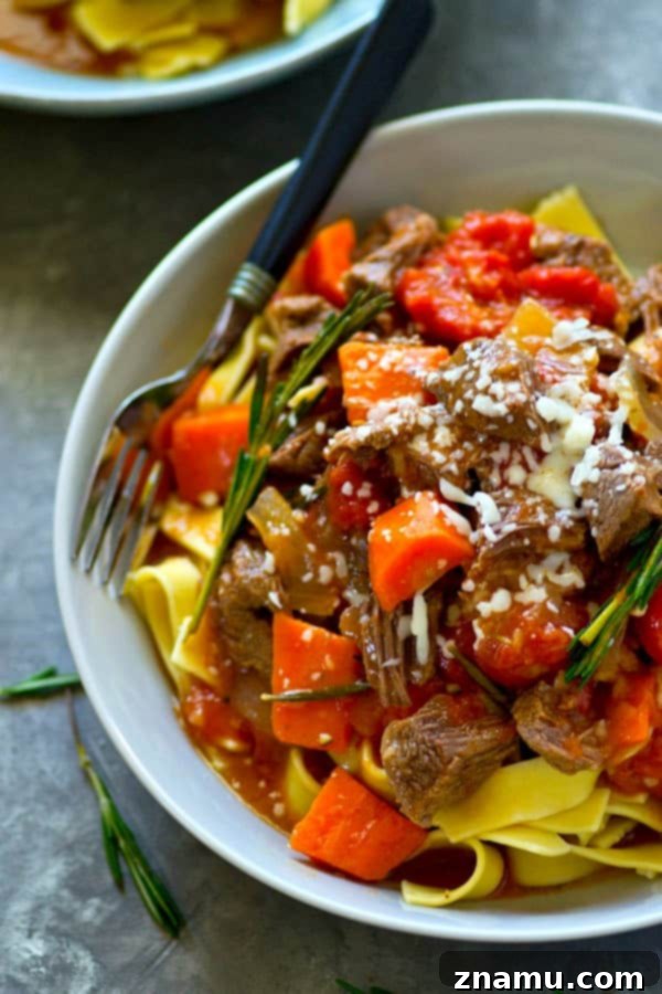 A large pot of freshly made Instant Pot Red Wine Beef Ragu, rich and dark, ready to be served with pasta.
