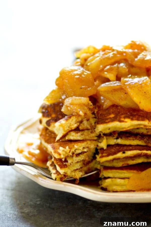 Brown Butter Cornmeal Stacks, Crowned with Apple-Pear Compote 2 Tall stack of fluffy browned butter cornmeal pancakes with rich apple pear compote cascading down the sides