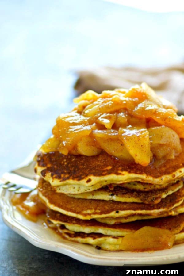 Brown Butter Cornmeal Stacks, Crowned with Apple-Pear Compote 5 Close-up of freshly made apple pear compote simmering in a saucepan, showing tender fruit slices and warm spices
