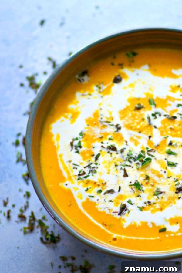 Comforting Ginger Roasted Butternut Squash and Apple Soup 4 Fresh butternut squash cubes and apple quarters on a baking sheet, drizzled with olive oil and fresh sage, ready for roasting.