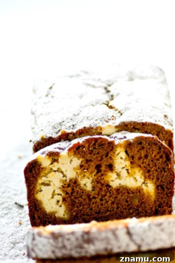 Marbled Gingerbread Cheesecake Bread 5 Many slices of Gingerbread Cheesecake Swirl Quick Bread arranged on a festive plate, ready to be enjoyed. Each slice prominently features the creamy cheesecake swirl, promising a delightful texture and taste combination.
