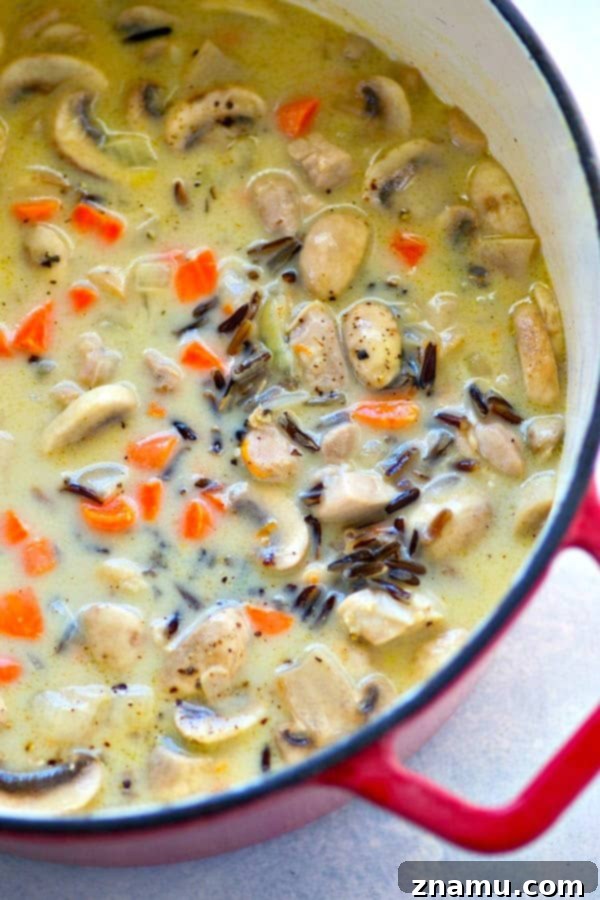 Hearty Creamy Chicken Mushroom Wild Rice Soup 4 Fresh ingredients for creamy chicken mushroom wild rice soup: neatly diced chicken, onions, carrots, minced garlic, and sliced mushrooms ready for cooking.