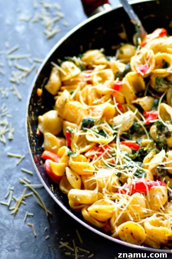 A wide shot of a skillet filled with the creamy orechiette pasta, ready to be served, showcasing its vibrant colors.
