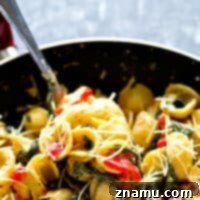 A creamy mascarpone sauce, roasted red peppers, and spinach are the most flavorful trio in this easy skillet orechiette pasta! 