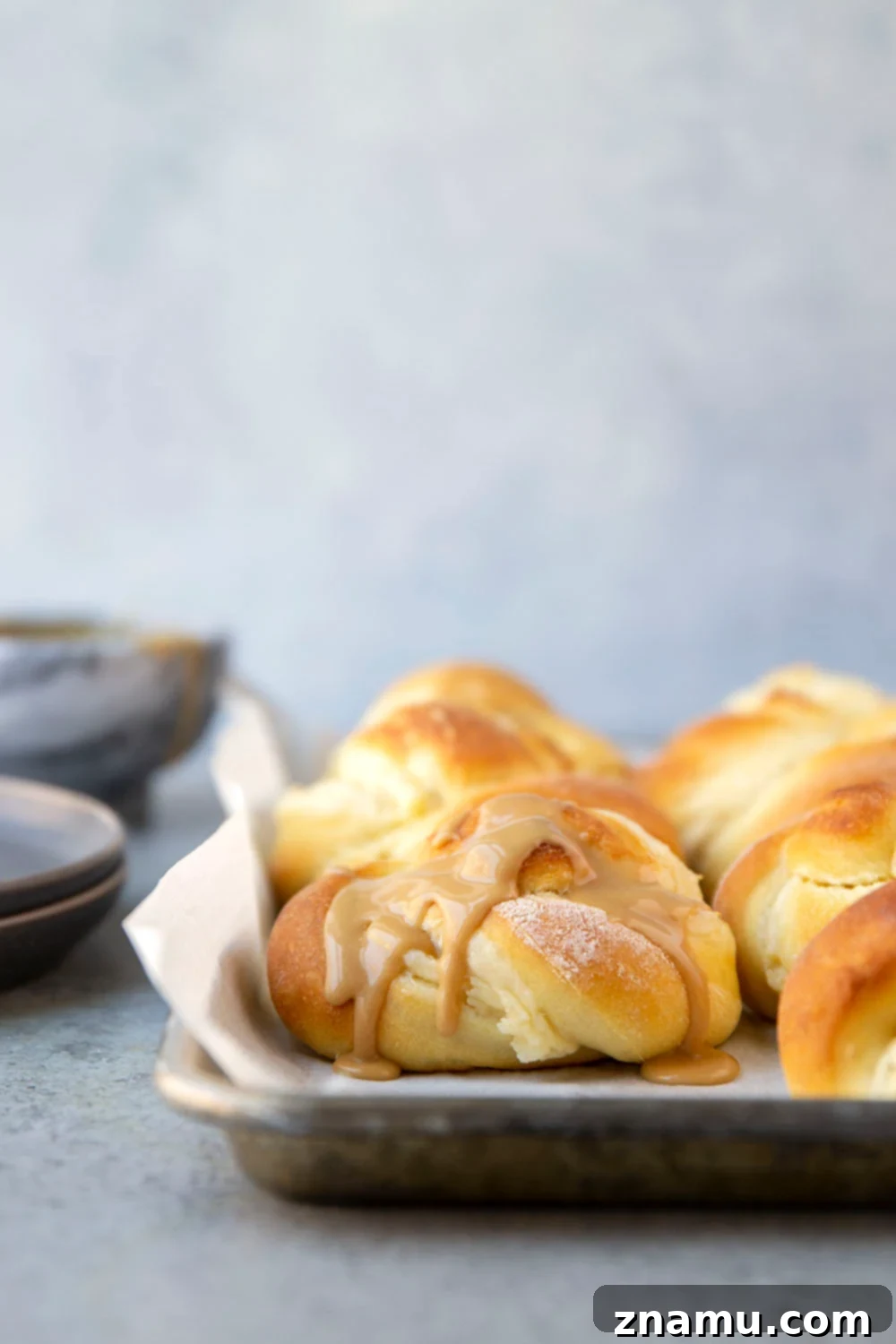 Decadent Cream Cheese Morning Buns with Coffee Glaze 2 Fluffy cream cheese morning buns generously drizzled with a sweet coffee glaze, fresh out of the oven, promising a perfect breakfast experience.