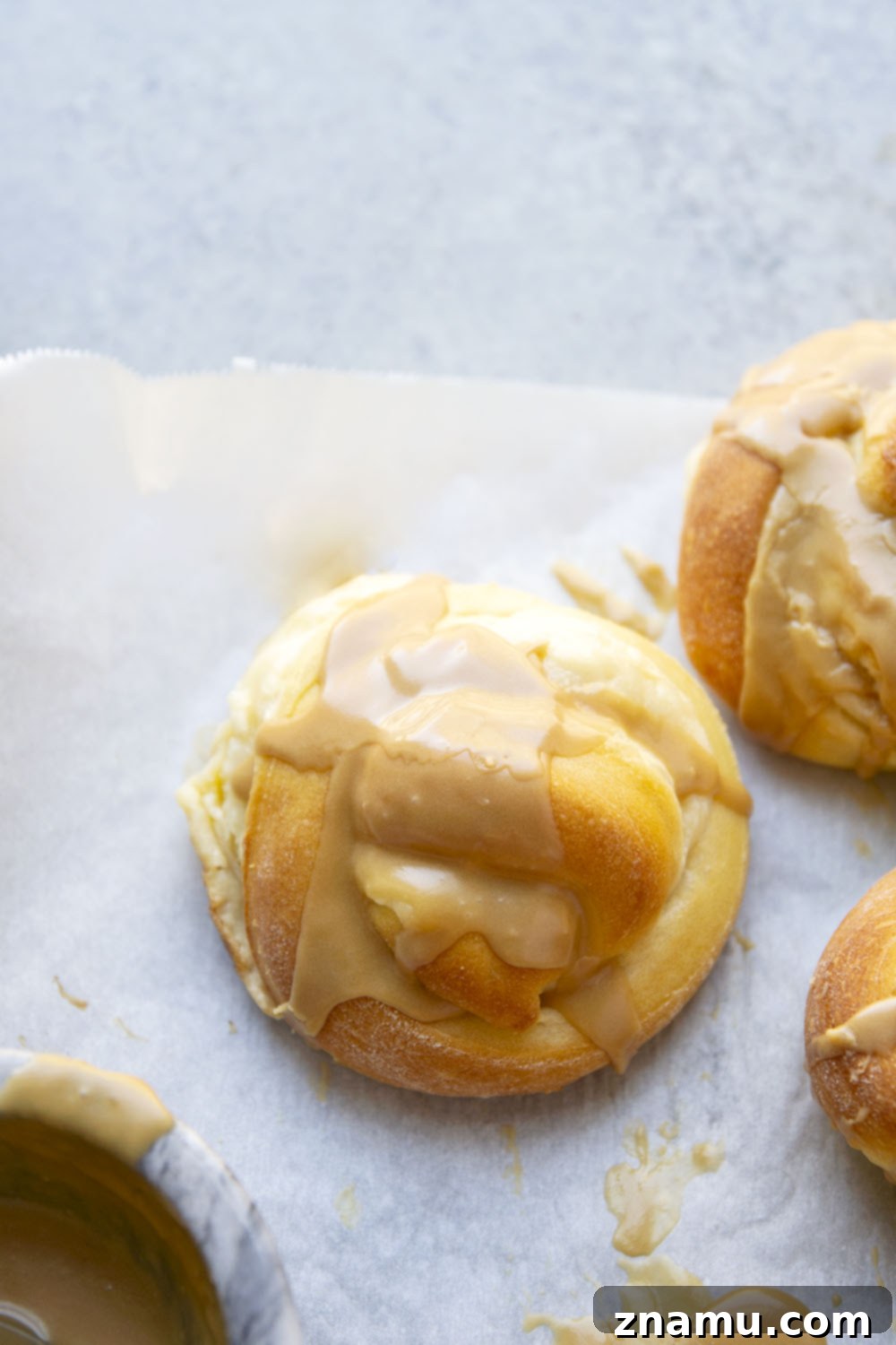 Decadent Cream Cheese Morning Buns with Coffee Glaze 7 A stunning spread of freshly baked cream cheese morning buns, still warm, with their coffee glaze glistening, ready to be enjoyed as a delightful breakfast.