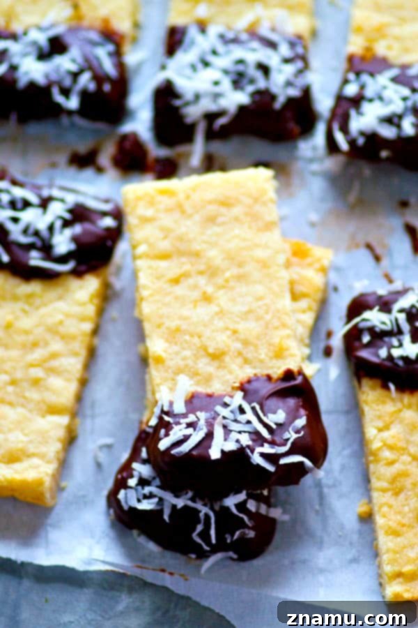 Coconut Shortbread Bars with Chocolate Drizzle 4 Soft, buttery coconut shortbread bars are dipped in melted chocolate and rolled in melted chocolate and rolled in coconut flakes for the ultimate holiday cookie bar!