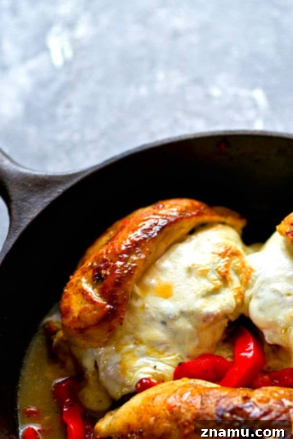 Italian-Style Stuffed Chicken with Roasted Peppers, Spinach, and Mozzarella 3 Close-up of a perfectly seared and baked chicken breast, revealing the creamy mozzarella and vibrant spinach and red pepper filling.