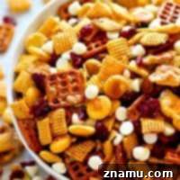 Sweet 'n' salty flavors pair with cranberries and white chocolate in this ADDICTING cranberry bliss snack mix! Make a big batch because it'll go fast!