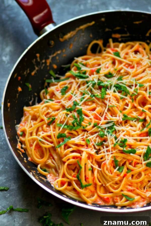 Light Roasted Red Pepper Fettuccine Alfredo 3 Close-up of creamy roasted red pepper fettuccine alfredo, highlighting the sauce texture and pasta strands.