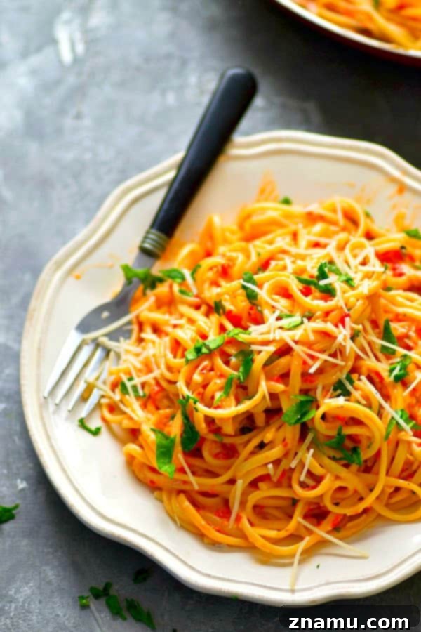 Light Roasted Red Pepper Fettuccine Alfredo 4 Ingredients for roasted red pepper alfredo sauce simmering in a saucepan.