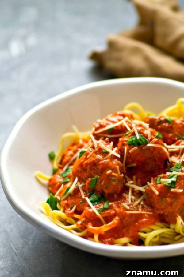 Delicious and tender red wine marinara meatballs served over pasta, made quickly in the Instant Pot