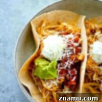 Homemade taco seasoning and a quick cook in the instant pot are the secrets behind this INCREDIBLY tender and flavorful taco shredded chicken! Perfect for topping tacos and salads!