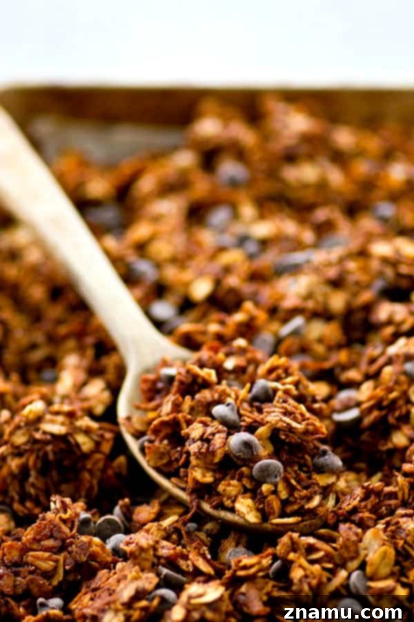 Rich Double Chocolate Chai Granola 4 Hands breaking apart a sheet of baked Double Chocolate Chai Spice Granola