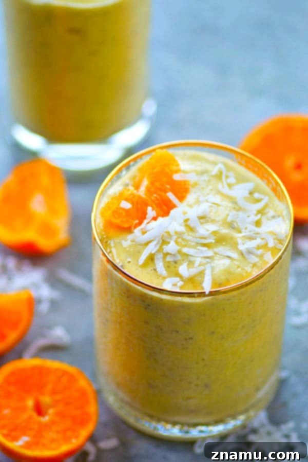 Mango Tango Coconut Power Boost 5 Another view of the Mango Orange Coconut Power Smoothie, highlighting its refreshing quality and the healthy ingredients it contains, perfect for energizing your day or recovering after exercise. The texture appears smooth and inviting.