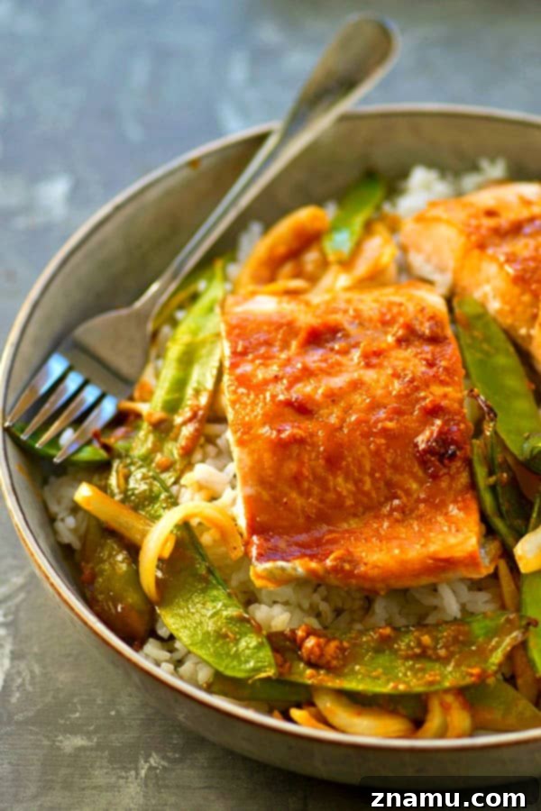 Easy One-Pan Hoisin Salmon and Snow Peas 5 Cooked hoisin salmon and snow peas served over a bed of fluffy white rice in a bowl.