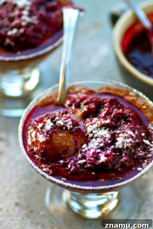 Decadent Chocolate Mousse with Wine-Infused Raspberries 2 Rich dark chocolate mousse topped with vibrant red wine raspberry sauce, a sophisticated and romantic dessert perfect for special occasions.