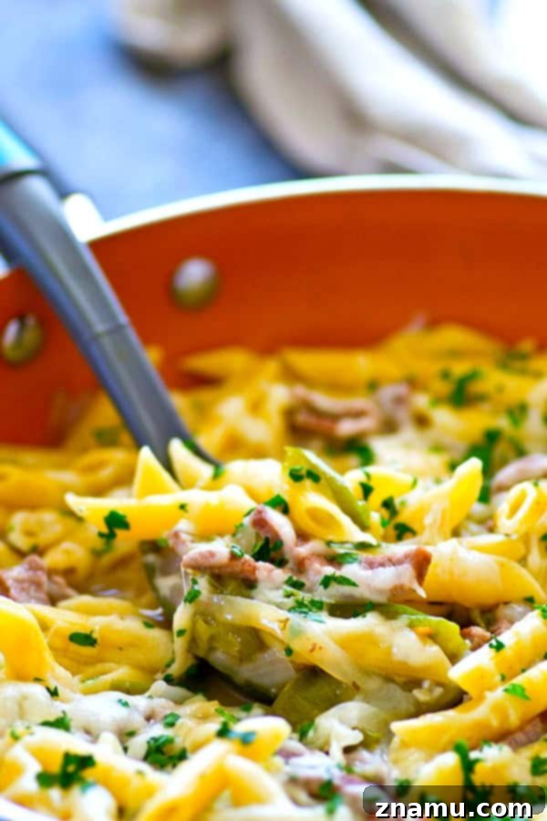 Single-Skillet Philly Cheesesteak Penne 2 One-Pot Philly Cheesesteak Penne Pasta served in a large skillet, ready to eat