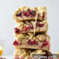 Three layers of a soft oatmeal crust, tangy orange cranberry filling, and lots of buttery streusel make up these cranberry crumb bars that are perfect for any holiday occasion!
