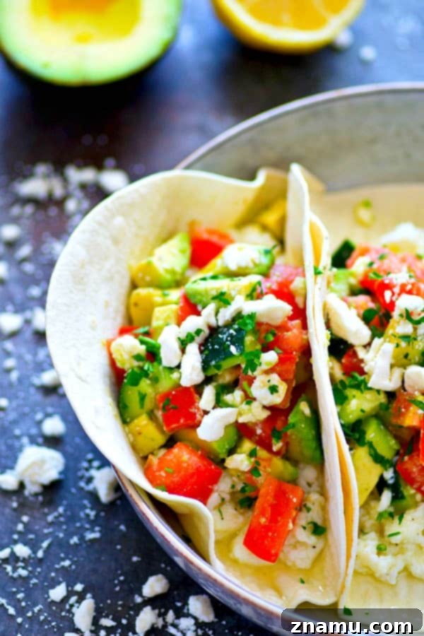 Mediterranean Morning Egg White Avocado Tacos 4 Ingredients for Greek Avocado Egg White Breakfast Tacos laid out: fresh vegetables, feta, and fluffy egg whites.
