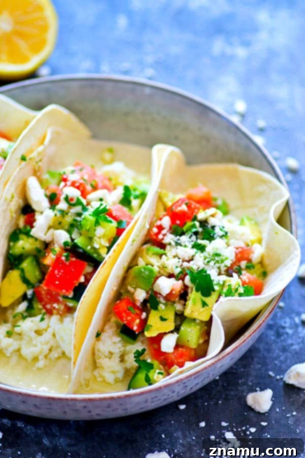 Mediterranean Morning Egg White Avocado Tacos 5 Close-up of a prepared Greek Avocado Egg White Breakfast Taco, garnished with extra feta and parsley.