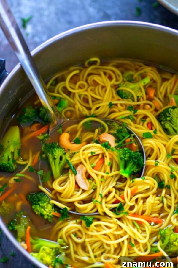 Another perspective of a steaming Broccoli Cashew Curry Noodle Broth Bowl.