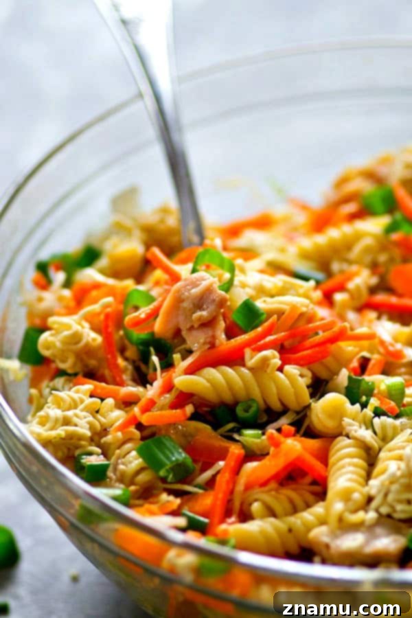 Vibrant Asian Chicken Crunch Pasta Salad with fresh vegetables and rotini pasta