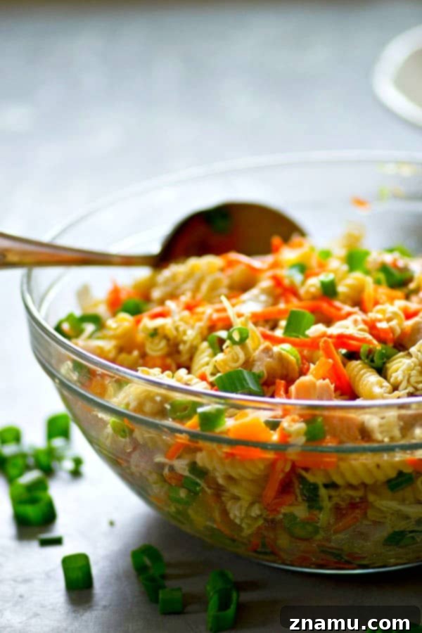 Close-up of the crunchy texture in Asian Chicken Pasta Salad, highlighting ramen noodles and fresh vegetables