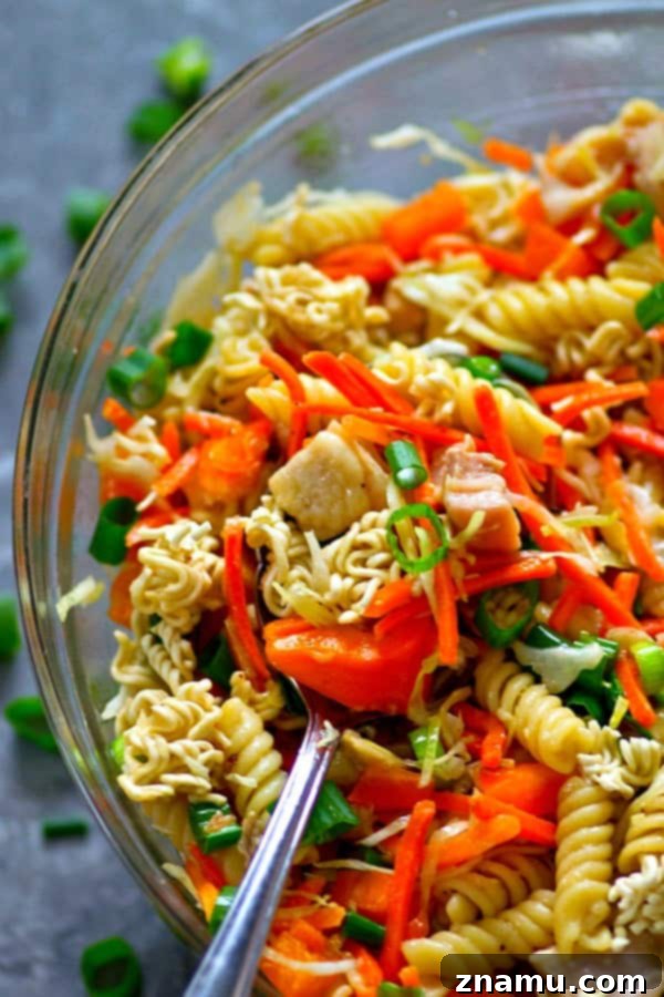 Homemade Asian Chicken Crunch Pasta Salad in a large serving bowl, ready to be enjoyed