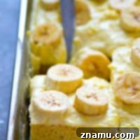 Dreamy Banana Cream Sheet Cake 7 A closer look at a slice of Banana Cream Pie Sheet Cake with whipped cream