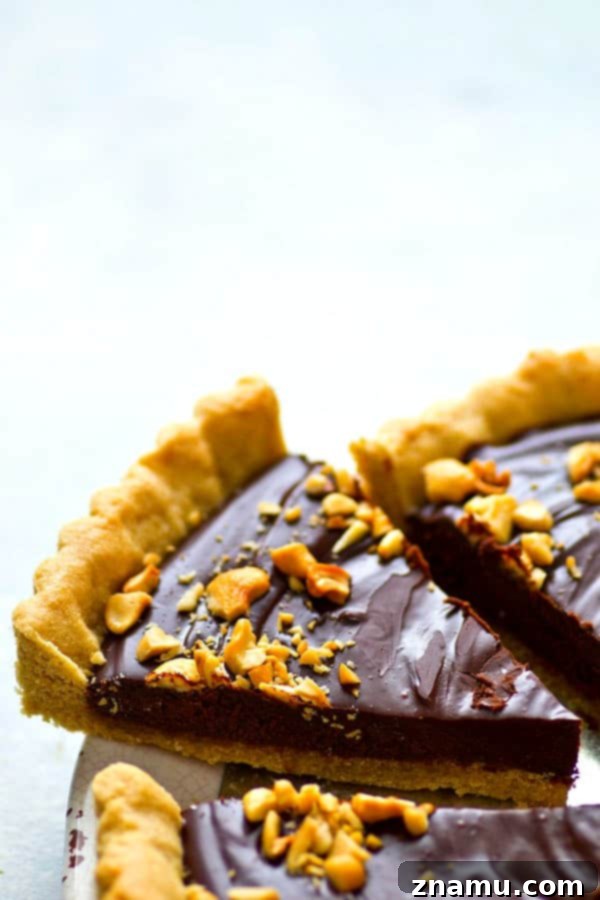 Indulgent Peanut Butter Chocolate Tart 2 A rich chocolate ganache filling and a soft, chewy peanut butter cookie crust create an irresistible chocolate ganache tart.