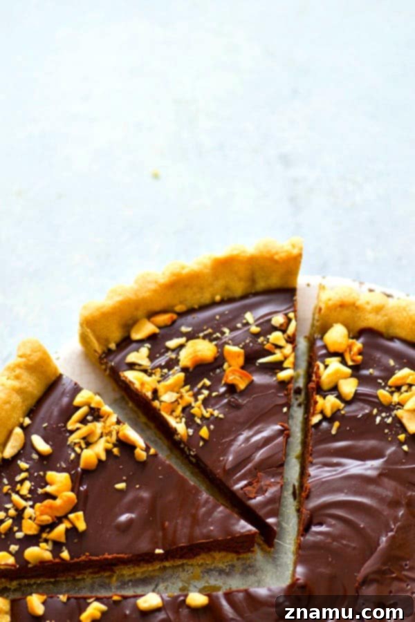 Indulgent Peanut Butter Chocolate Tart 4 Close-up of the smooth, dark chocolate ganache filling in a peanut butter cookie tart.