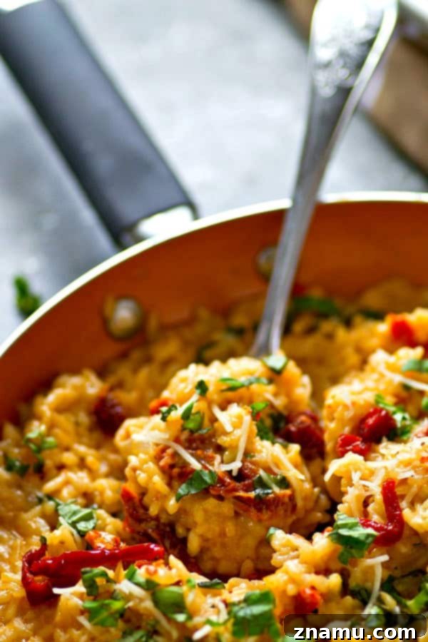 Sun-Dried Tomato, Basil & Cream Cheese Risotto 3 Close-up shot of Sun-Dried Tomato and Basil Risotto, showcasing the vibrant red sun-dried tomatoes and lush creamy consistency.